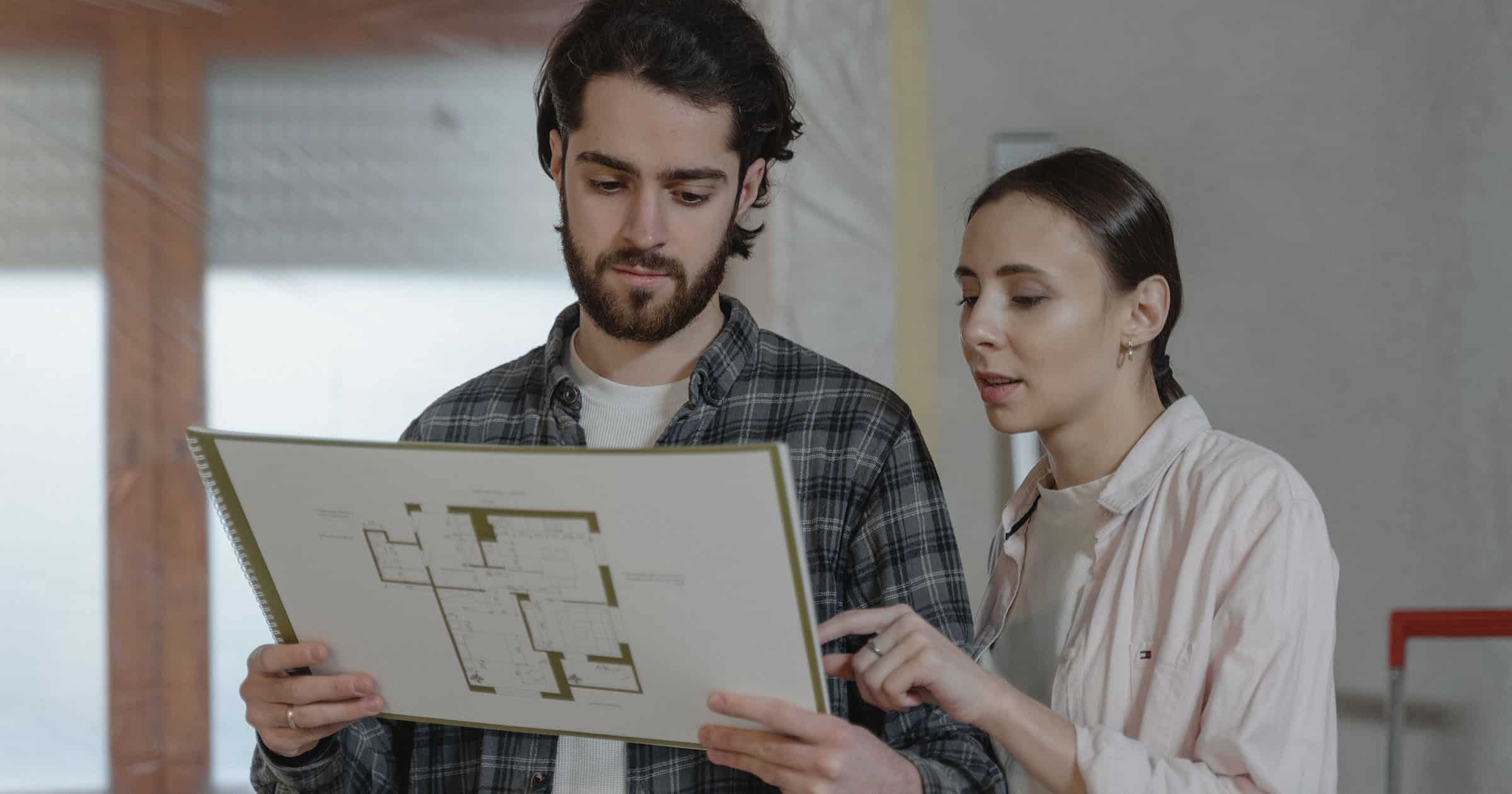 couple looking at floor plans for kitchen remodel