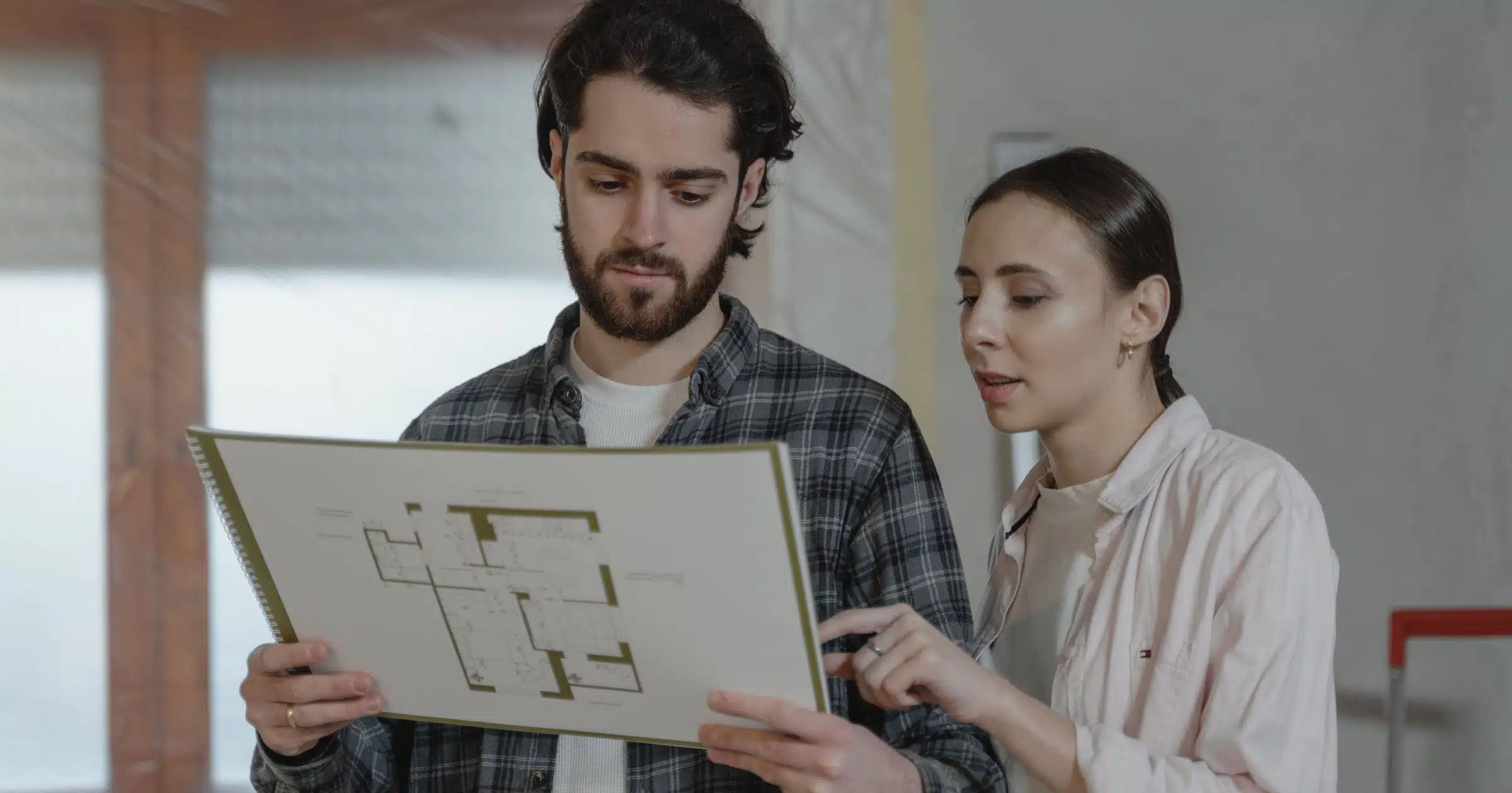 floor-plans-for-kitchen-remodel-in-evansville couple looking at floor plans for kitchen remodel