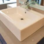 cultured marble countertop with white China vessel bowl and modern faucet fixture