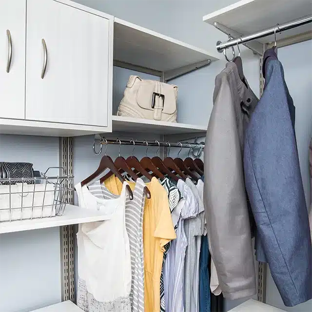 white shelving system inside bedroom closet